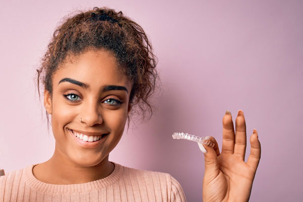 photo of woman with clear aligners